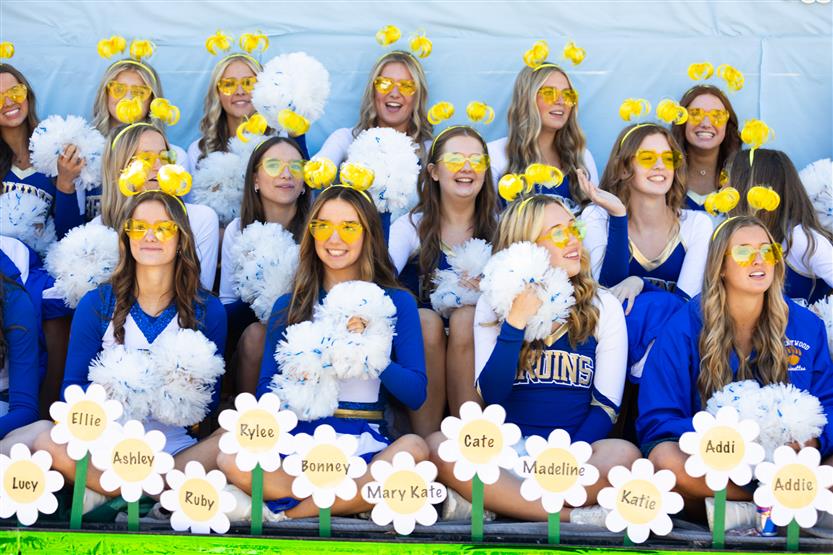 Students ride on a homecoming parade float
